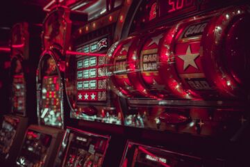 Close-up view of vintage slot machines with vibrant lights and symbols in a casino setting
