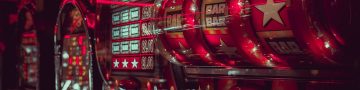 Close-up view of vintage slot machines with vibrant lights and symbols in a casino setting